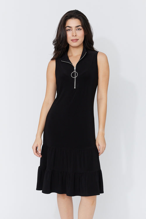 Robe Noire Zip Volant Compli K (33952) — pour la femme qui réinvente la petite robe noire à chaque porté, qui la choisit quand l’occasion mérite d’être à la hauteur et qui sait qu’un détail change tout