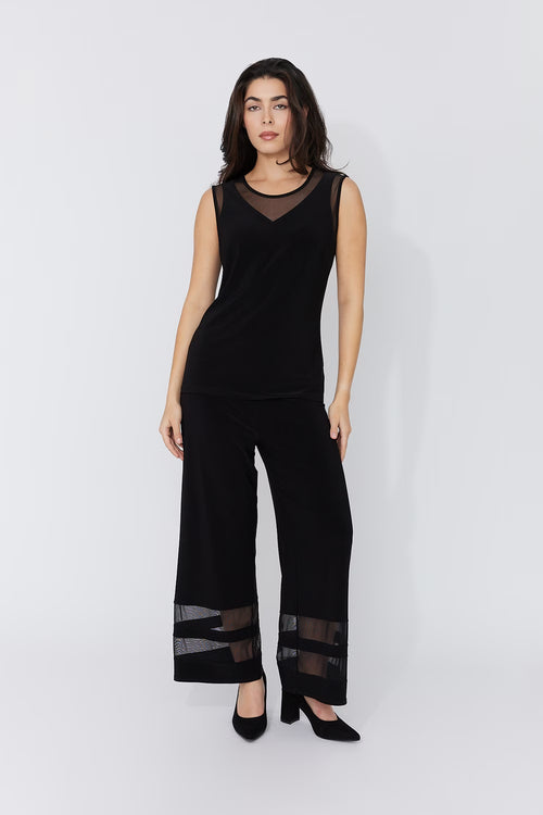 Pantalon jambe large Compli K 50183 : détails mesh transparents aux chevilles, design unique. Parfait pour soirées et occasions spéciales. Style audacieux.