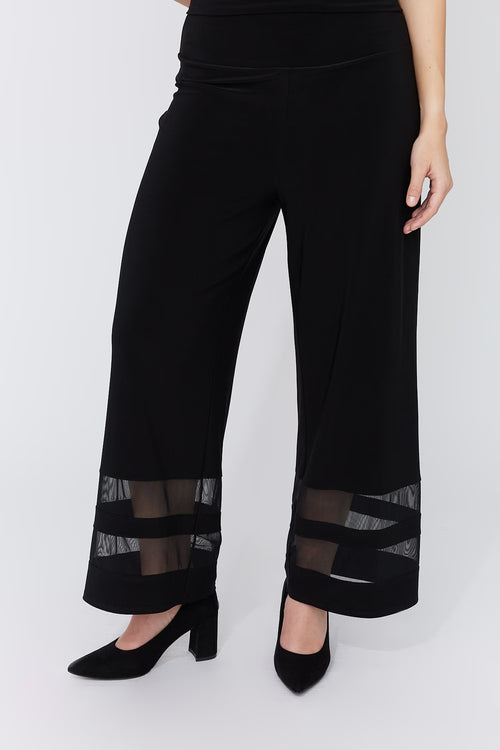 Pantalon jambe large Compli K 50183 : détails mesh transparents aux chevilles, design unique. Parfait pour soirées et occasions spéciales. Style audacieux.